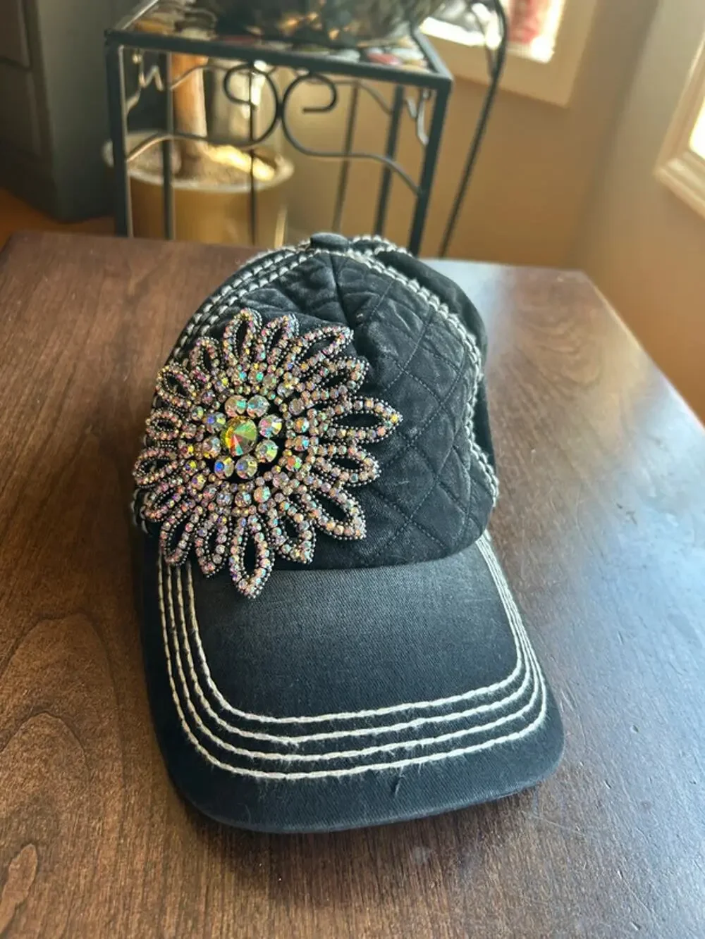Olive & Pique quilted baseball cap featuring an iridescent rhinestone flower